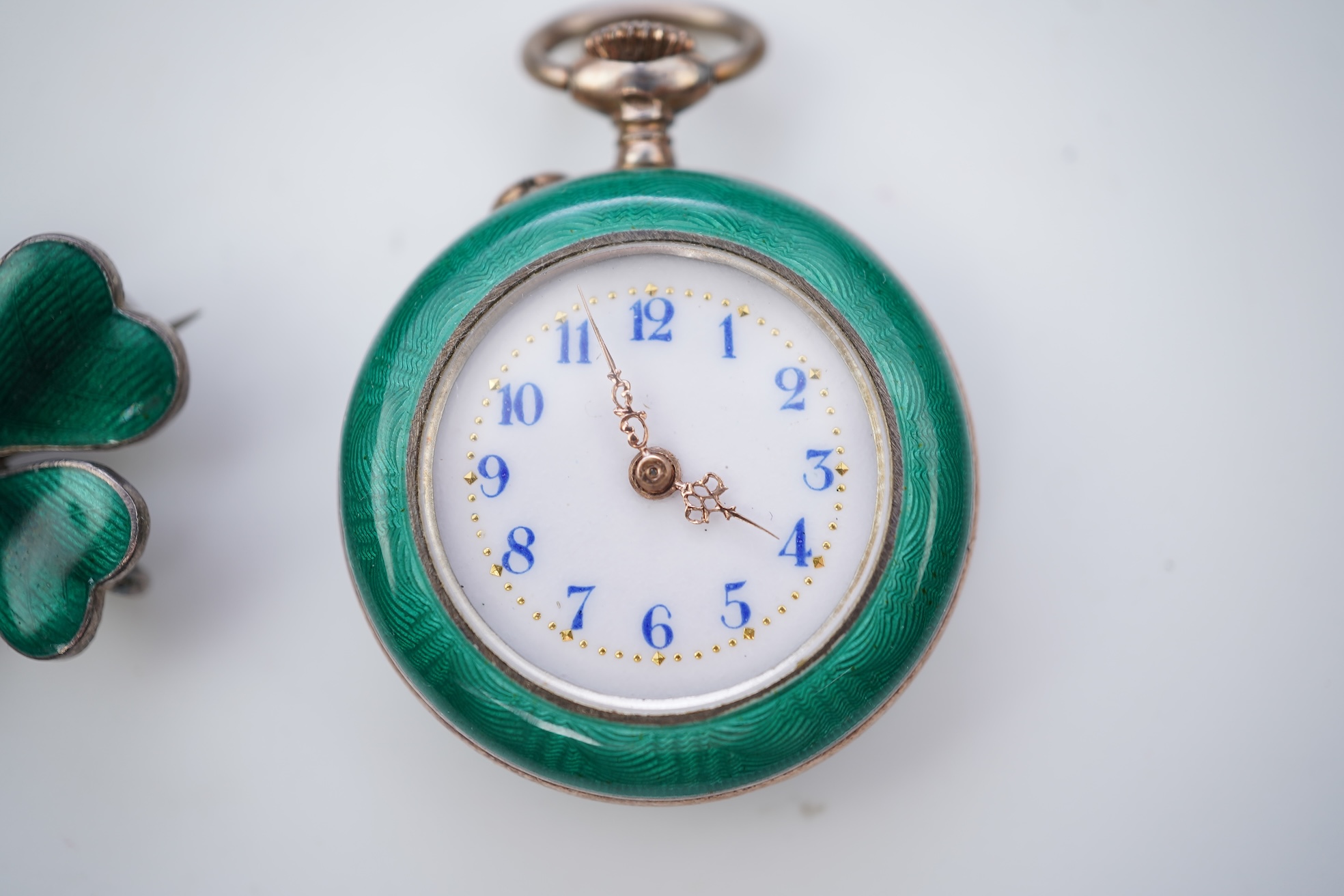 An enamel pocket watch and brooch, early 20th century